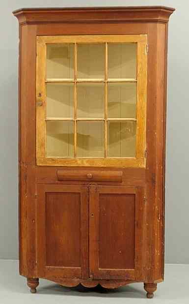 Appraisal: One-piece pine corner cupboard early th c with a molded