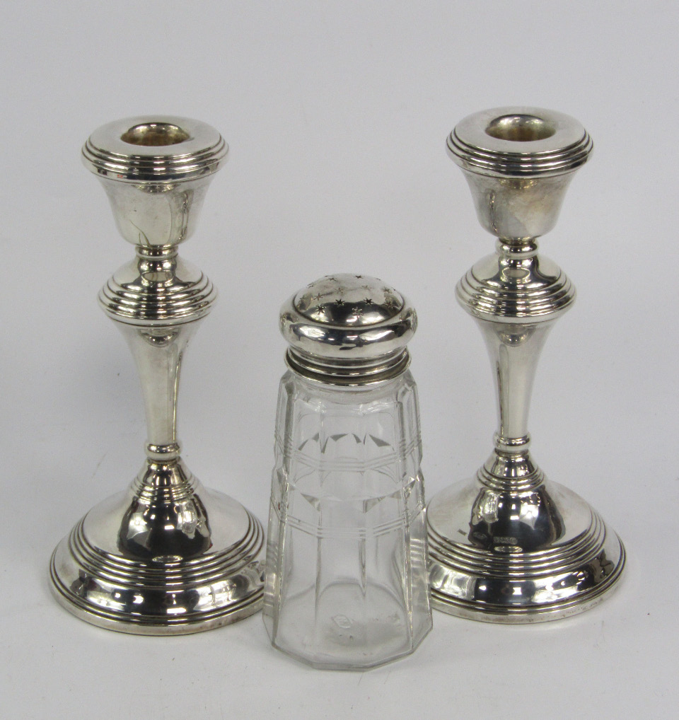 Appraisal: A pair of loaded silver candlesticks Birmingham cm high and