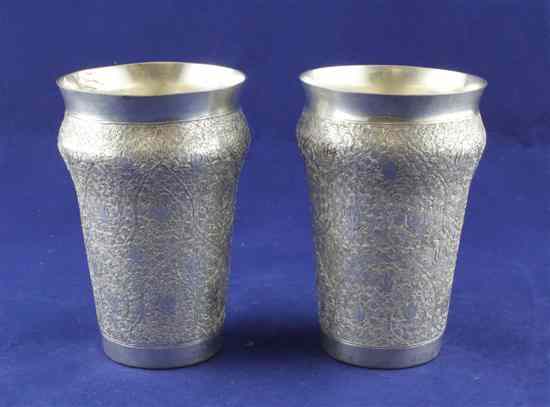 Appraisal: A pair of Indian white metal beakers with baluster shoulders