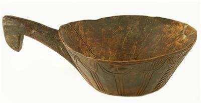 Appraisal: A treen single handled scoop with incised stylised tree decoration