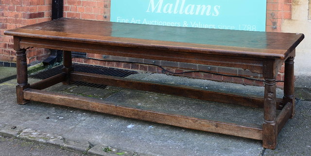 Appraisal: A Georgian oak refectory style tableof rectangular form on circular