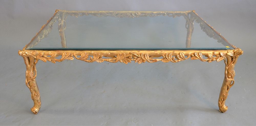 Appraisal: Large glass-top coffee table having carved composite gilded base ht