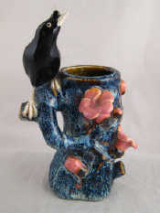 Appraisal: A Chinese ceramic vase modelled as a blackbird on a