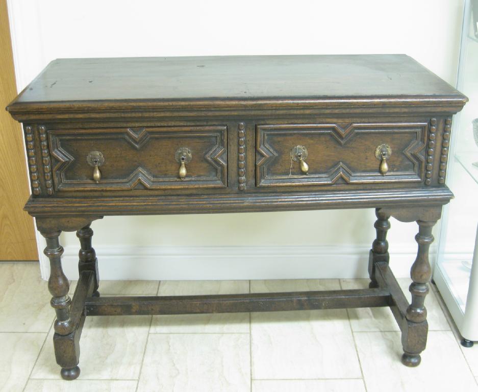 Appraisal: A Jacobean style oak Dresser Base fitted two drawers with