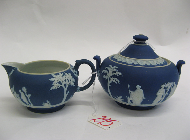 Appraisal: PAIR WEDGWOOD BLUE JASPERWARE CREAM SUGAR white classical relief figures