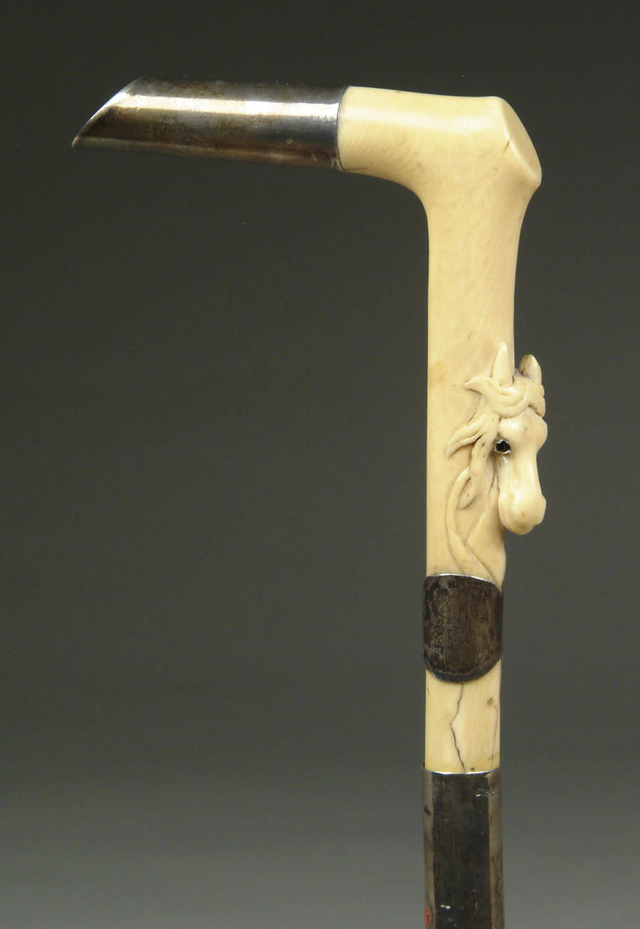 Appraisal: CARVED IVORY AND STERLING SILVER HORSE HEAD SWORD CANE L-shaped