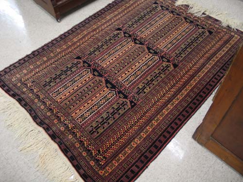 Appraisal: TRIBAL AFGHAN BELOUCH AREA RUG the black field divided into