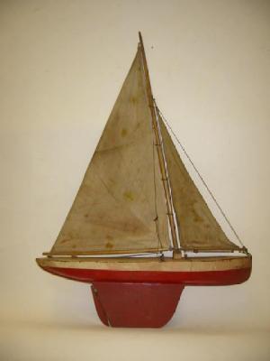 Appraisal: A sailing yacht with white deck and red tinplate hull