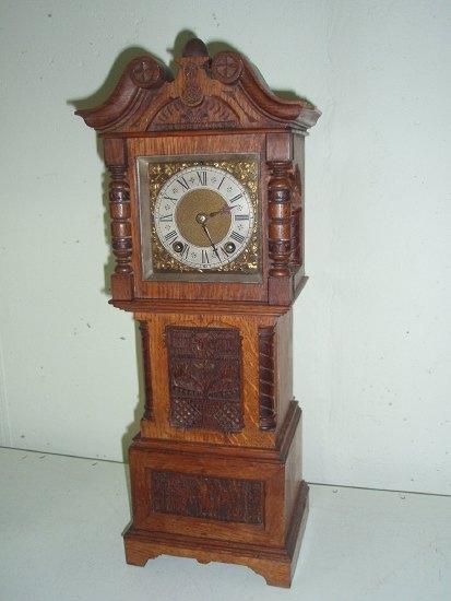 Appraisal: An oak cased miniature longcase clock the square dial with