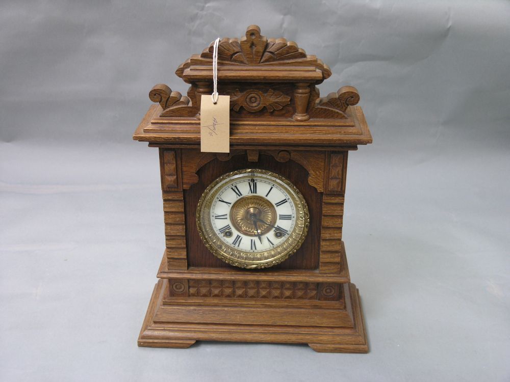 Appraisal: An Ansonia mantel clock with enamelled dial in carved architectural