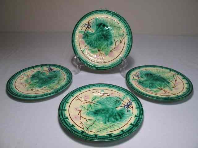 Appraisal: Four Majolica pottery plates in the grape leaf and Greek