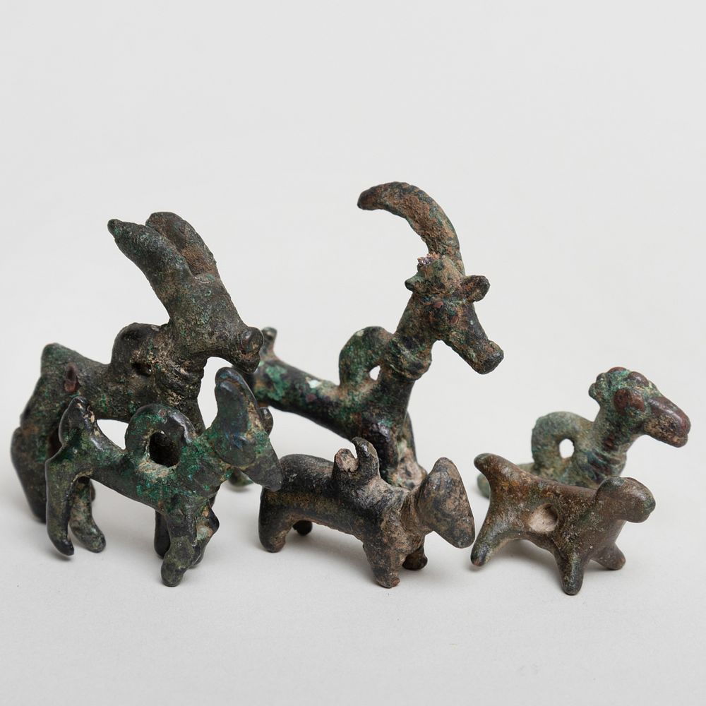 Appraisal: Group of Six Luristan Bronze Amulets Together with An Etruscan