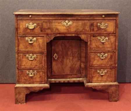 Appraisal: A good George II walnut crossbanded and herringbone inlaid kneehole