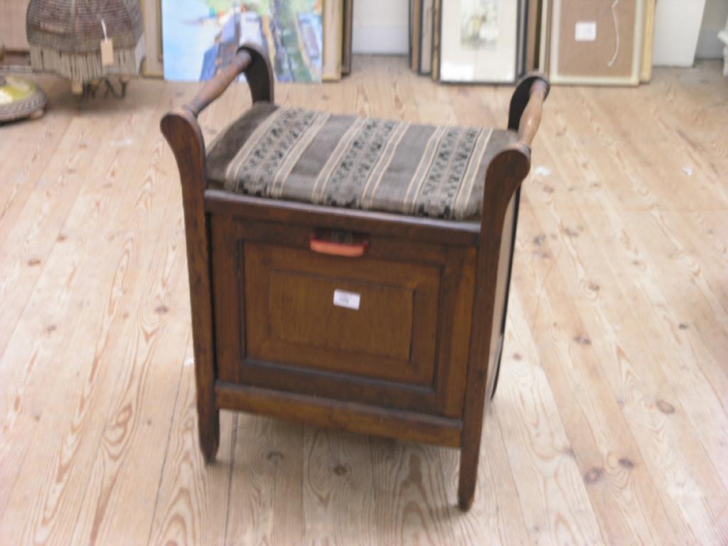 Appraisal: A stained beech piano stool with hinged cupboard base