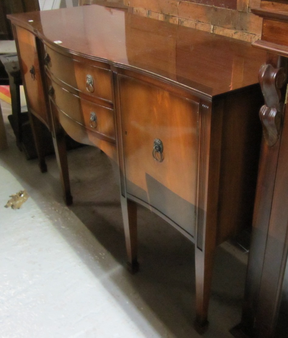 Appraisal: A th century mahogany bowfront sideboard with a pair of