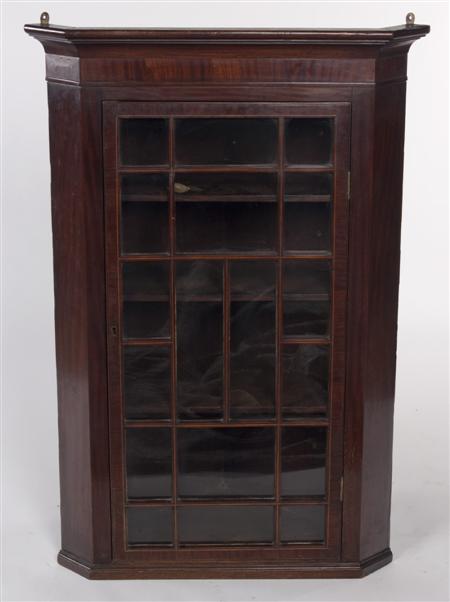 Appraisal: A George III mahogany corner cupboard the projected moulded cornice