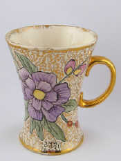 Appraisal: An unusual Moorcroft mug decorated with a hand painted floral