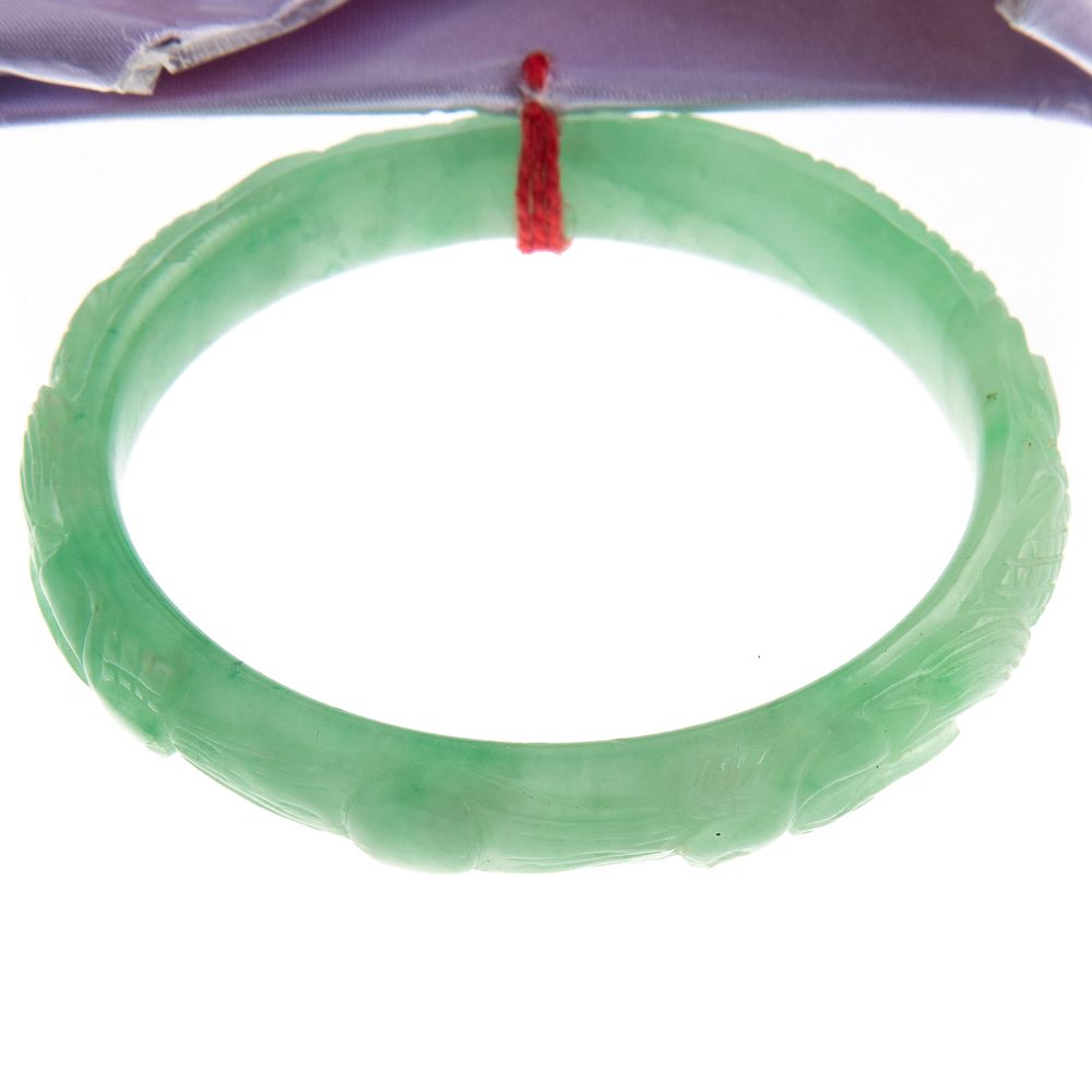 Appraisal: A Lady's Carved Natural Jade Bangle Natural jade slip on