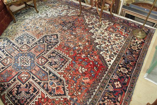 Appraisal: HAND KNOTTED RUG Geometric medallion in the Heriz style on