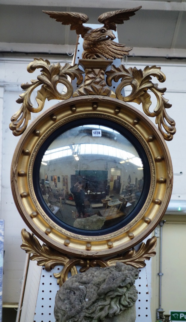 Appraisal: A Regency style gilt framed convex wall mirror with eagle