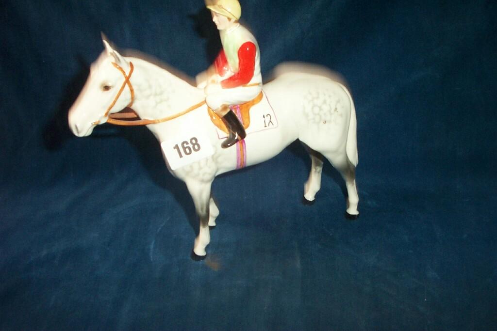 Appraisal: A Beswick equestrian figure of a jockey in red grey