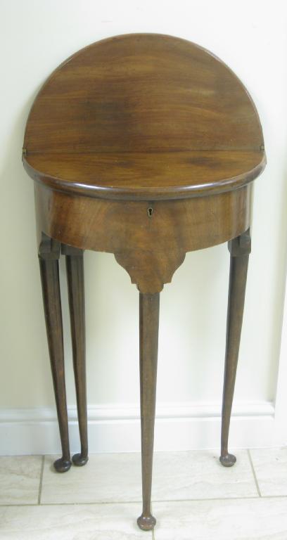 Appraisal: A small antique mahogany Tea Table with semi-circular fold-over top