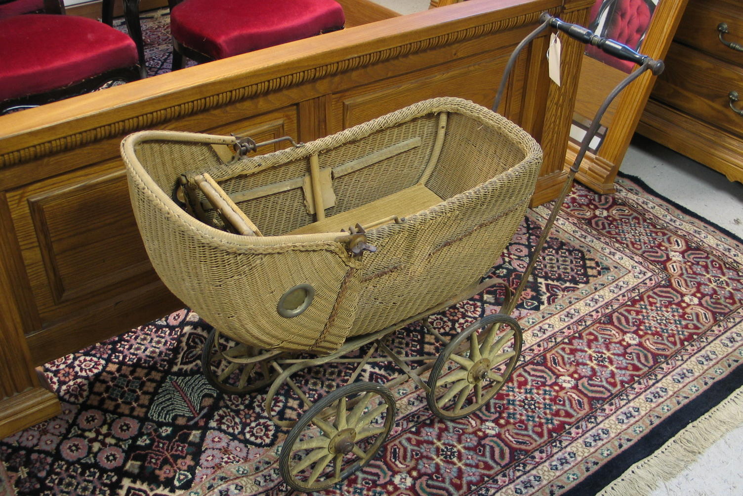 Appraisal: WICKER BABY BUGGY American c the woven wicker basket-like carriage