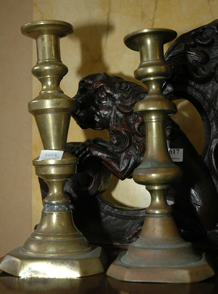 Appraisal: A PAIR OF BRASS CANDLESTICKS Together with a brass trivet