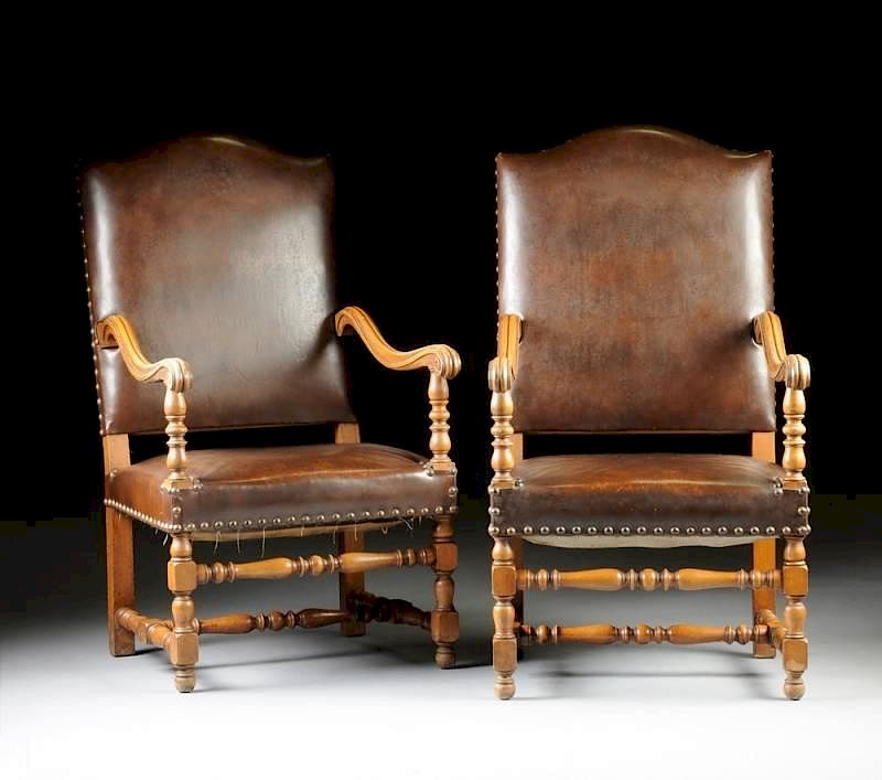 Appraisal: A PAIR OF BAROQUE STYLE NAILED BROWN LEATHER UPHOLSTERED CARVED