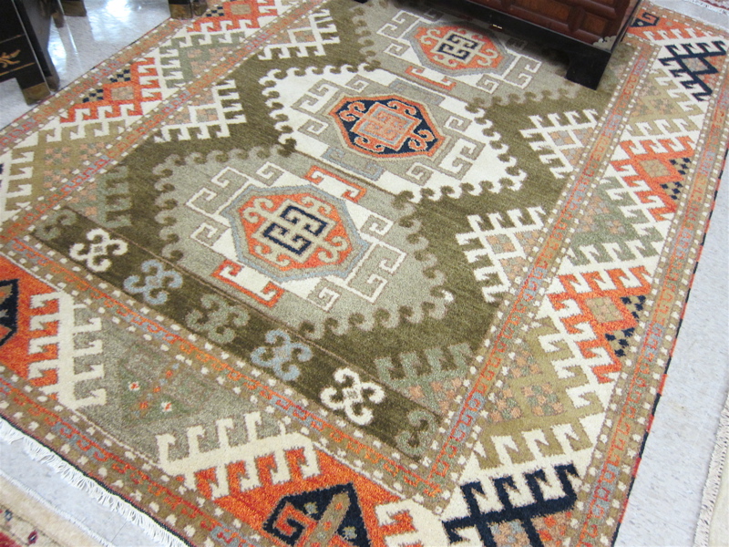 Appraisal: HAND KNOTTED ORIENTAL CARPET Indo-Caucasian three geometric medallion Kazak design