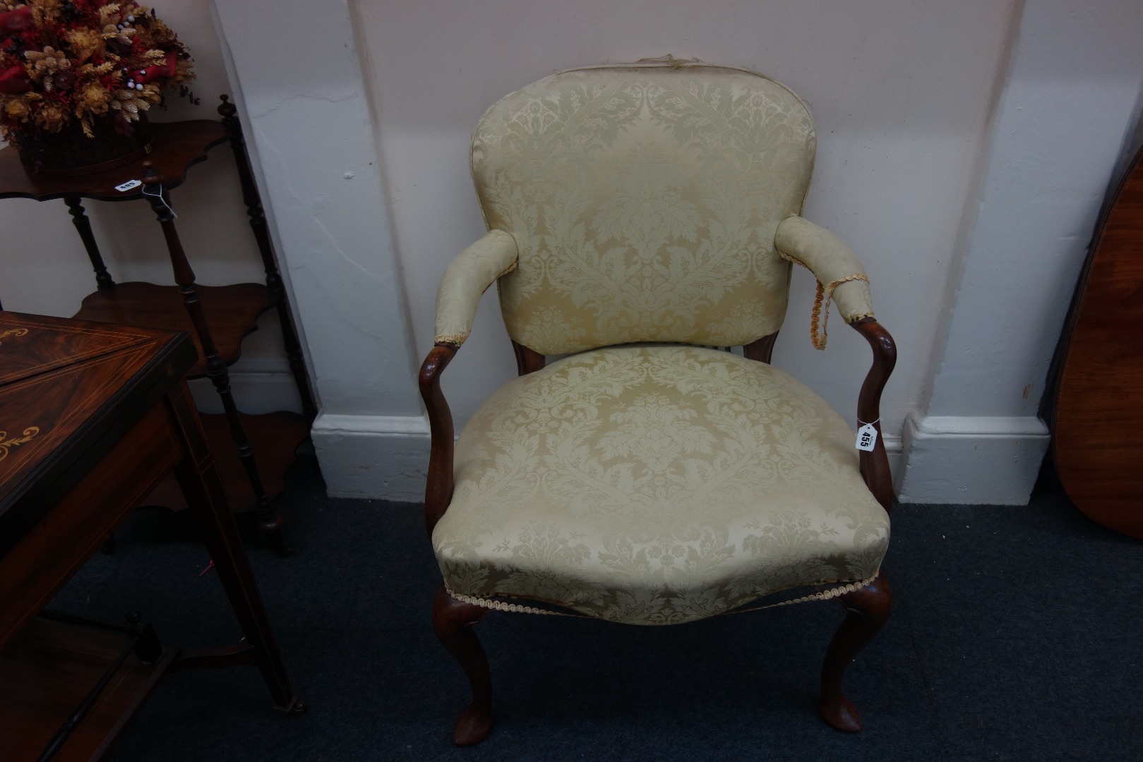 Appraisal: A mid th century mahogany frame upholstered armchair with curved