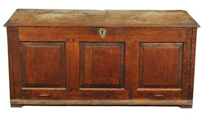 Appraisal: An oak chest the moulded edge boarded top above a