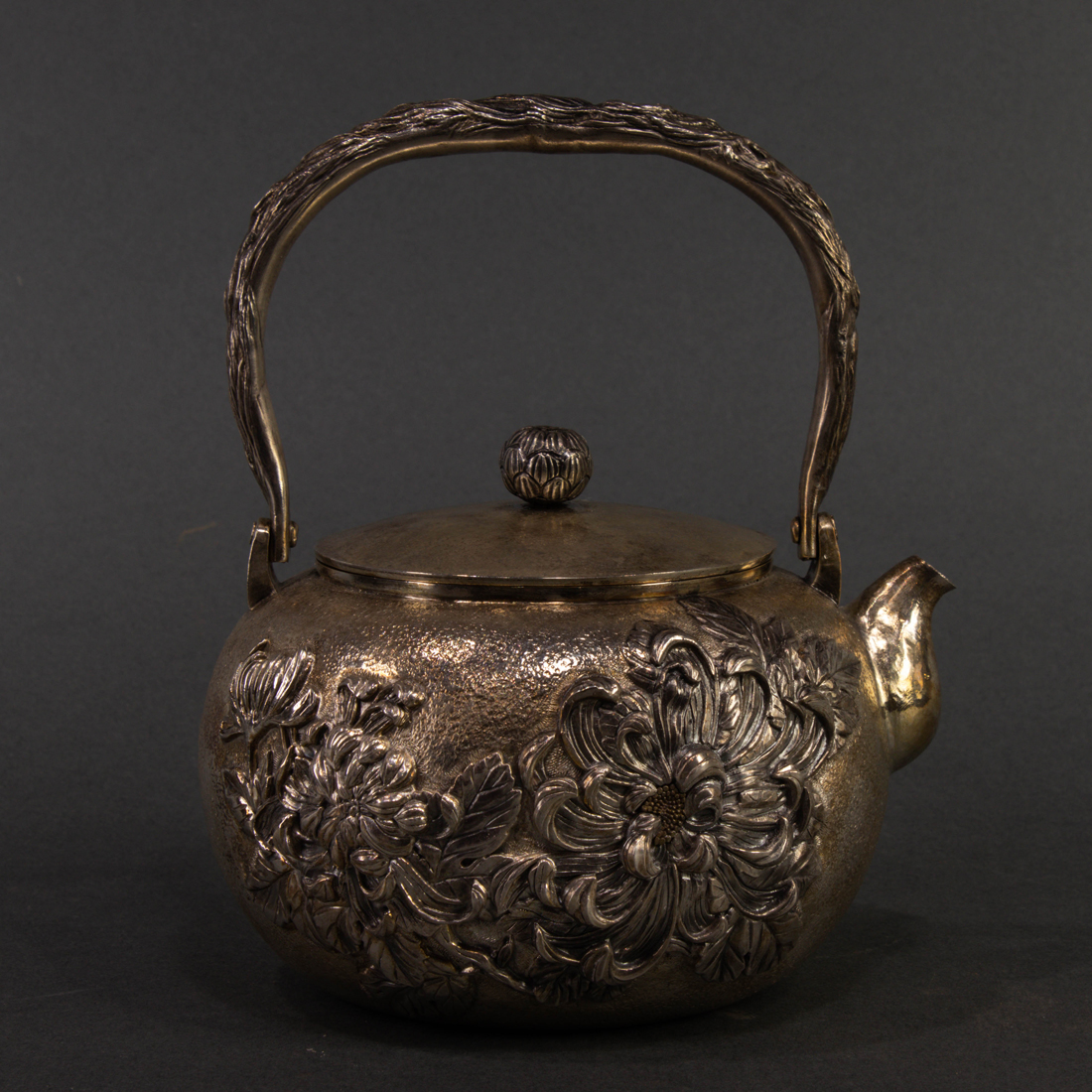 Appraisal: Japanese silver teapot of globular form with a tree trunk