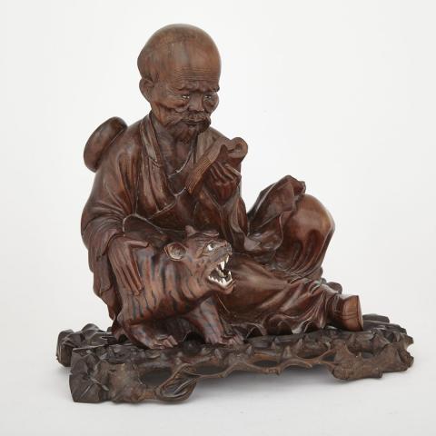 Appraisal: Hardwood Carving of a Man and a Tiger th Century