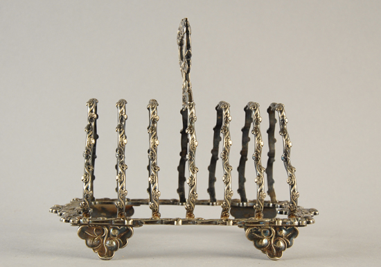 Appraisal: English Silverplate Toast Rack elaborate floral design H W D