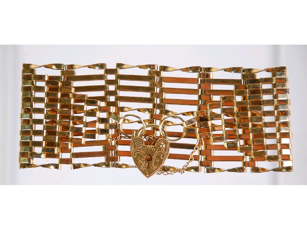 Appraisal: ct GOLD BROAD GATE PATTERN BRACELET with padlock clasp wide