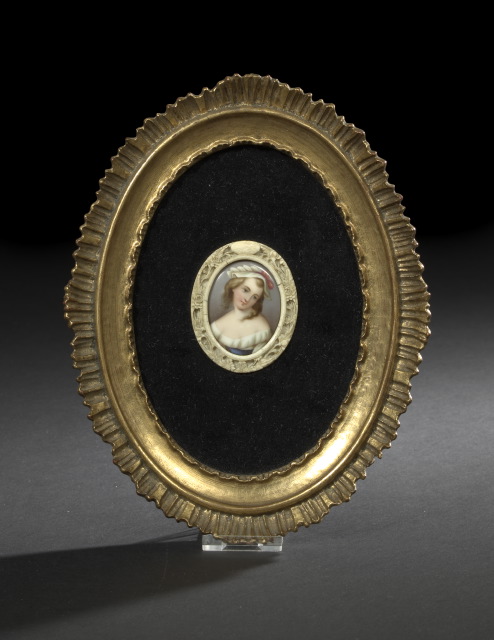 Appraisal: German Carved Bone-Enframed Oval Porcelain Portrait Miniature of a Coy