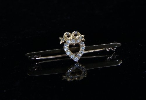 Appraisal: A bar brooch centred by a diamond set heart cm