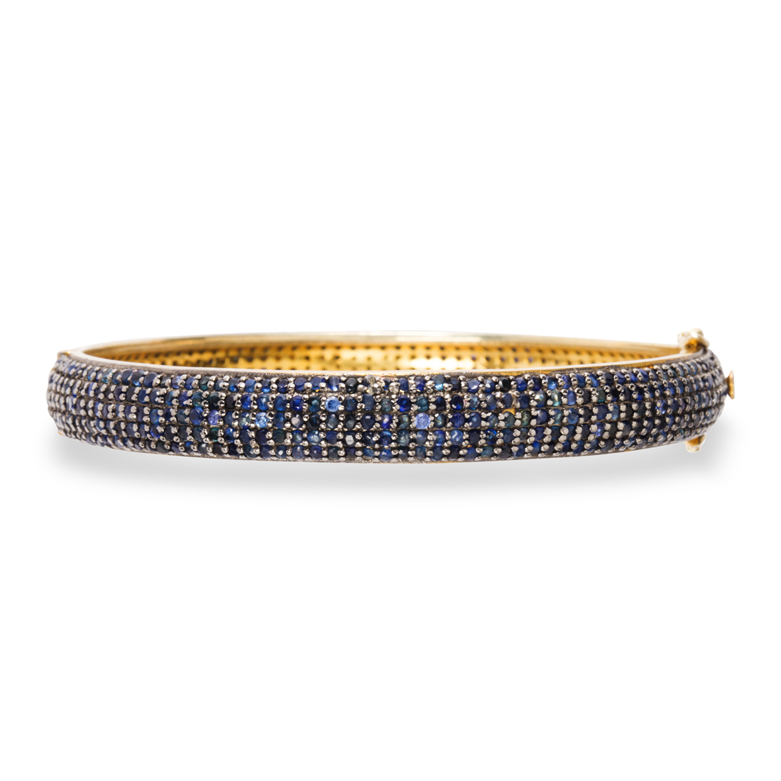 Appraisal: A SAPPHIRE BANGLE A sapphire bangle designed as a hinged