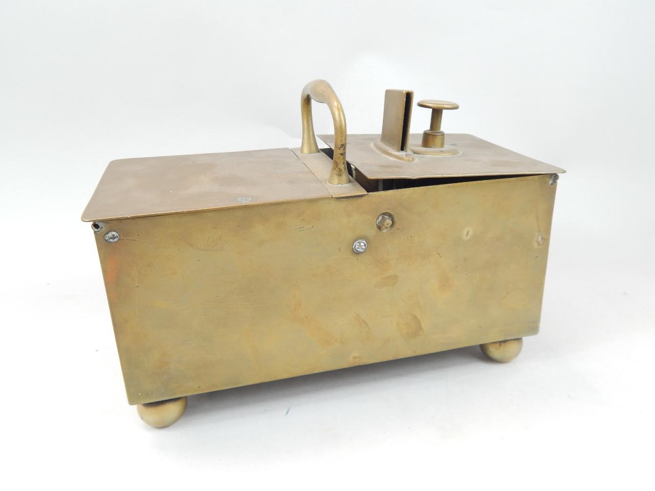 Appraisal: A brass coin operated tobacco dispenser with a shaped handle