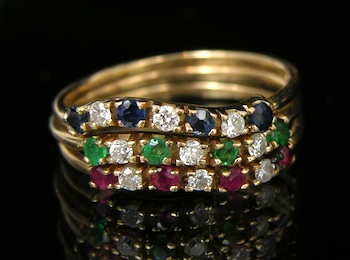 Appraisal: A Set of Three Stacking Rings set with Rubies Sapphires