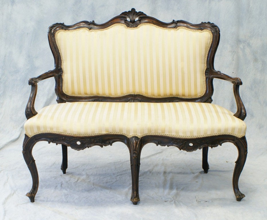 Appraisal: Carved Victorian settee in the French style shell and C-scroll