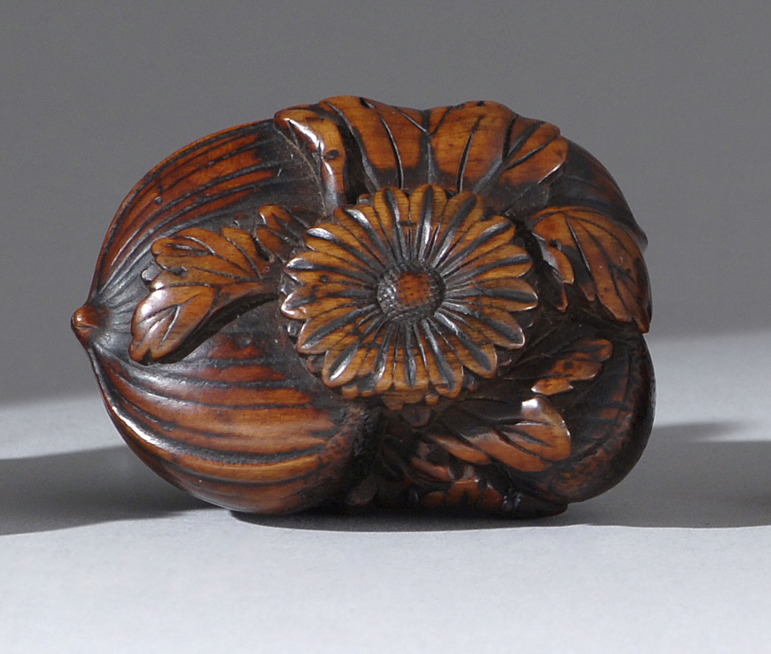 Appraisal: WOOD NETSUKE Circa In the form of chestnuts chrysanthemum and