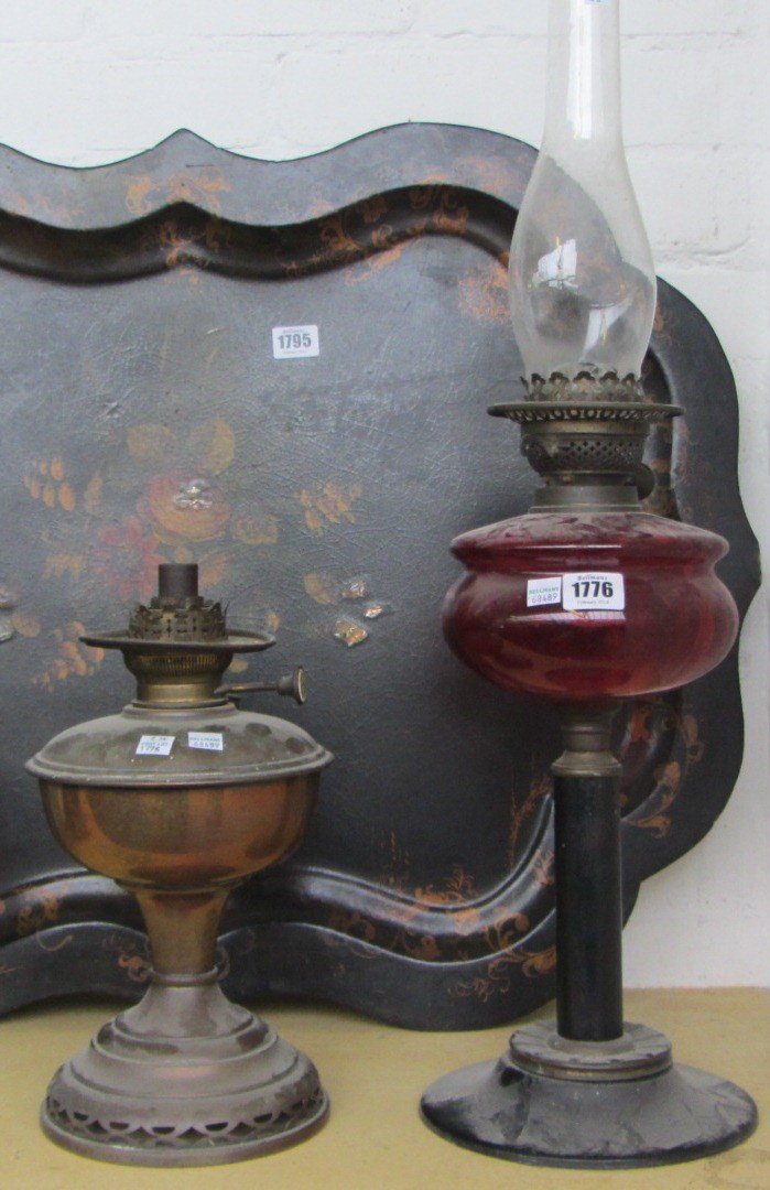 Appraisal: An early th century oil lamp with cranberry glass reservoir