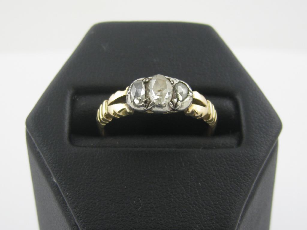 Appraisal: A Diamond three stone Ring the rose-cut stones close-set in