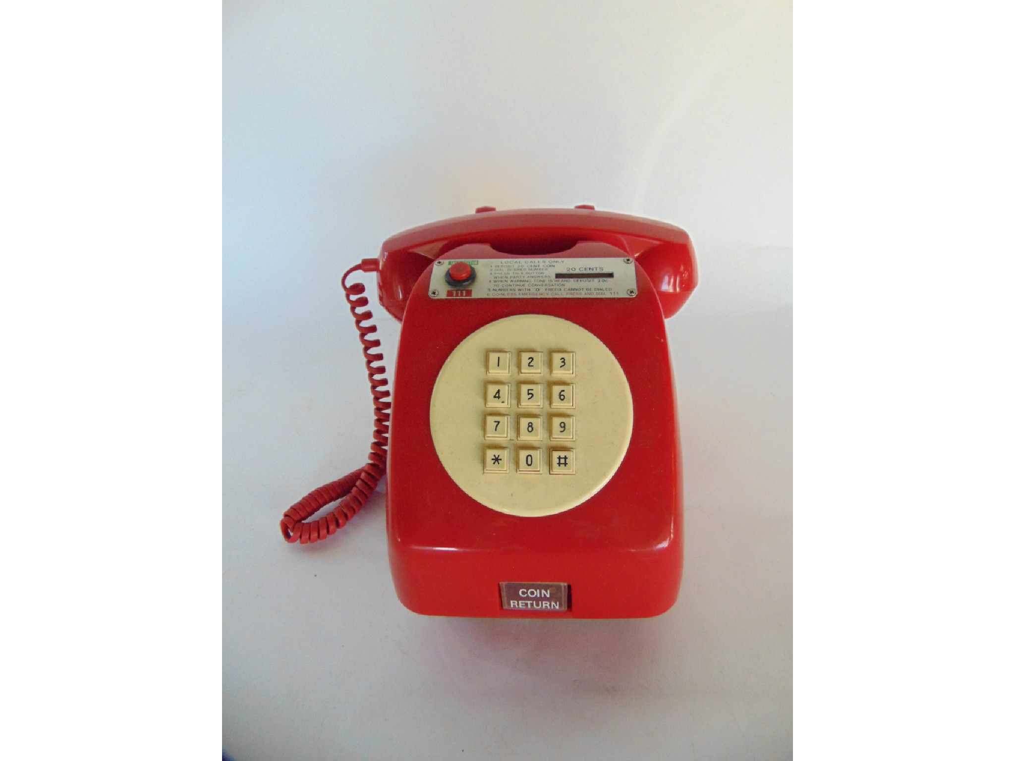 Appraisal: A vintage red Bakelite cased payphone unit bearing metallic plaque