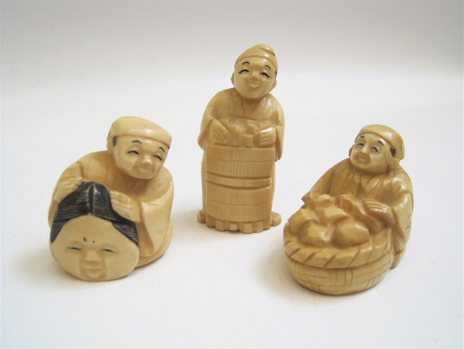 Appraisal: THREE JAPANESE IVORY CARVED NETSUKE each depicting a man one