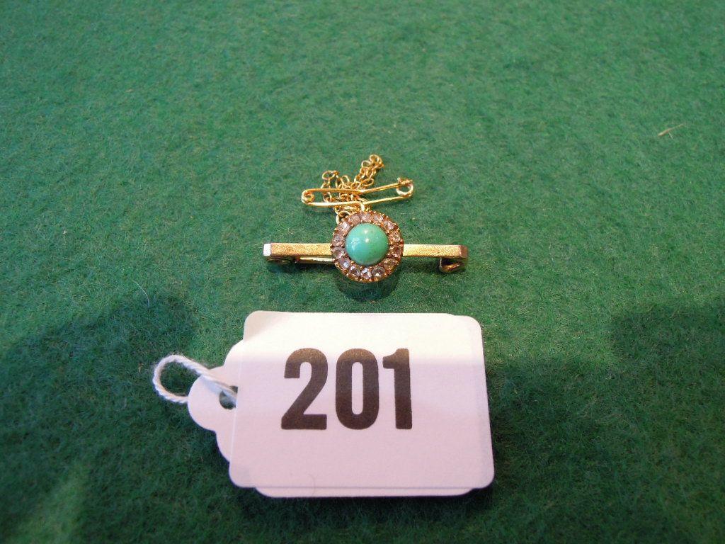 Appraisal: A small bar brooch set with a central turquoise surrounded