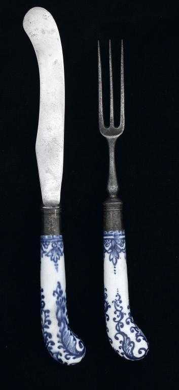 Appraisal: A DERBY PISTOL-HAFTED STEEL KNIFE AND FORK painted in underglaze