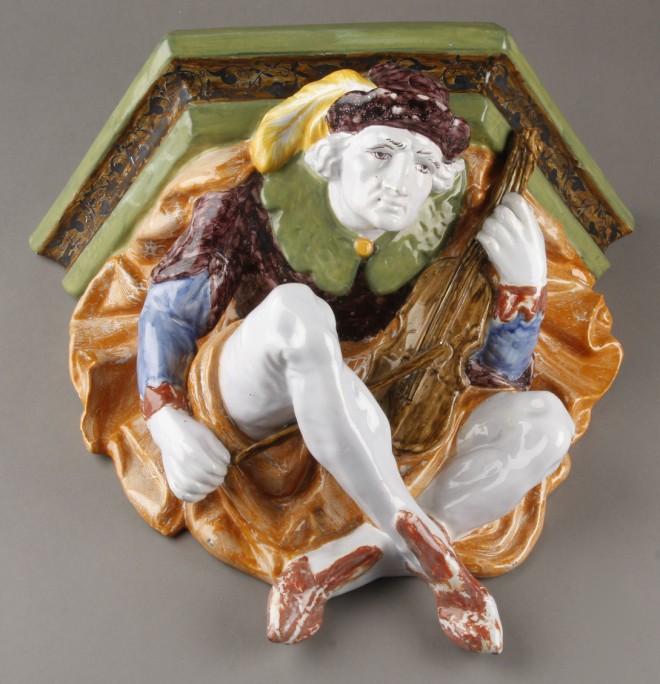 Appraisal: Wall shelf with man playing violin holding shelf on back